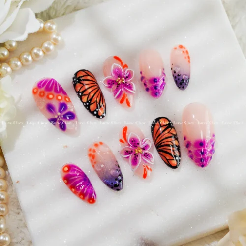 almond press on nails with butterfly orchid floral details from LuxeClaw