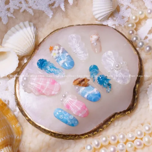 Summer Breeze ocean nail set with jellyfish blues shell textures pearls and soft pink accents