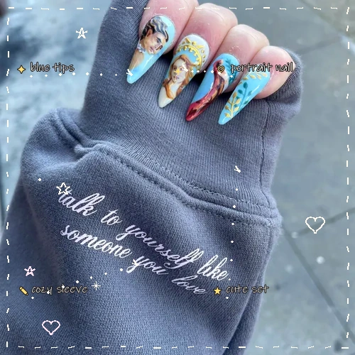 Blue custom press on nails on a gray sleeve with hand-drawn doodle notes
