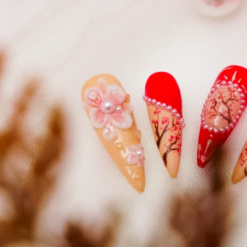 Glossy floral press-on nails styled for cozy fall events and dinners