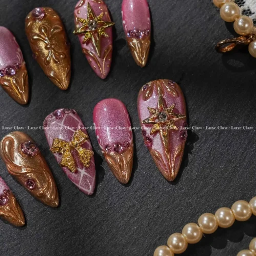 close view of pink press-on nails with shimmer, bow accents, and glossy finish